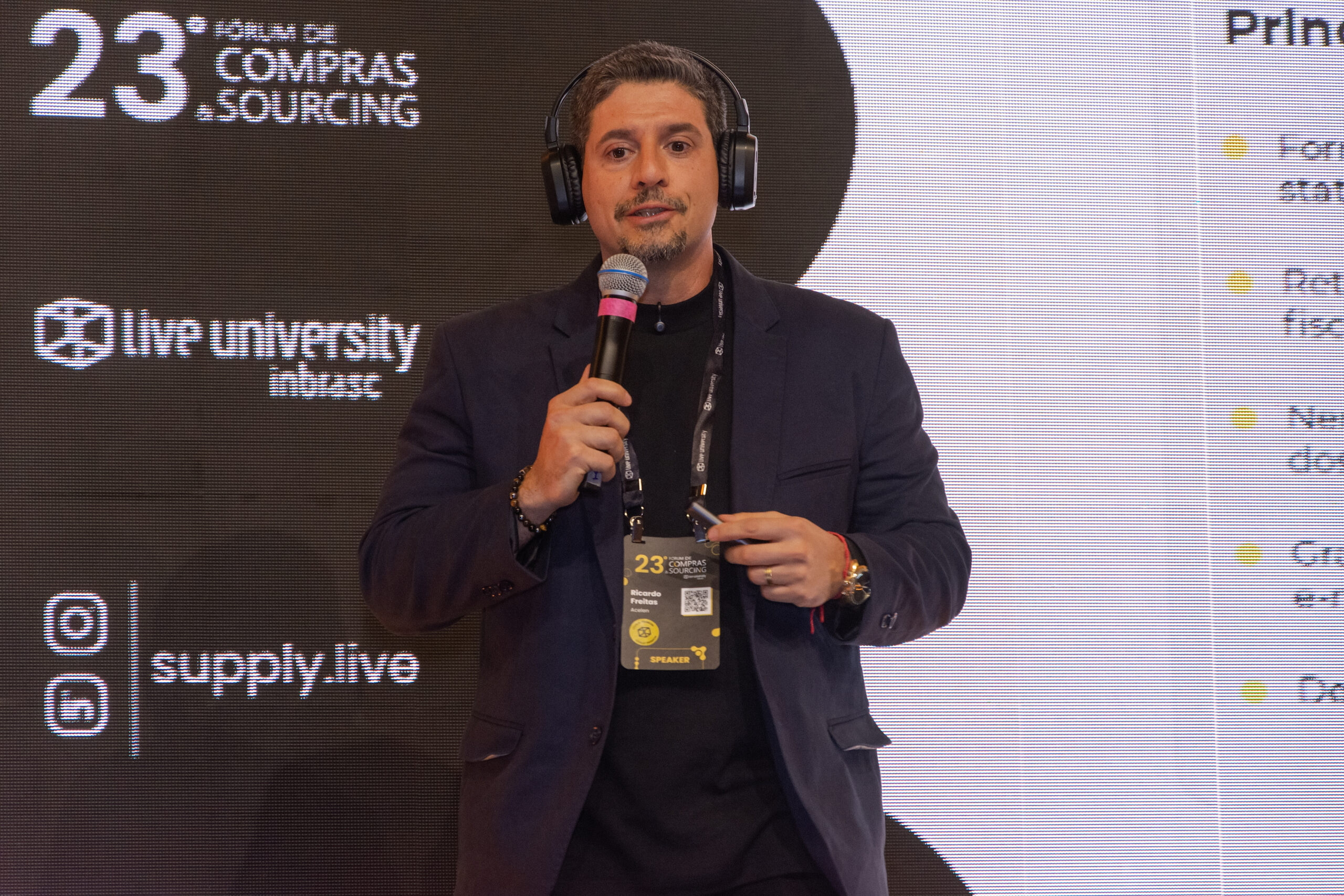 Ricardo Freitas, com microfone, durante sua palestra no Fórum de Compras 2026.